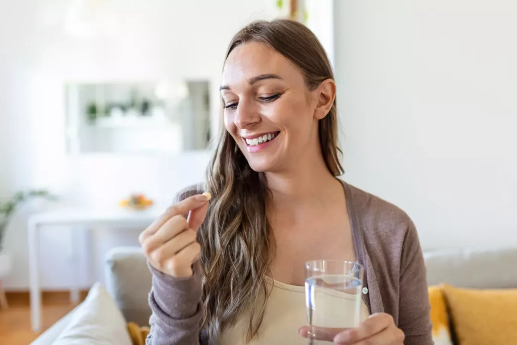 Woman taking oral HRT medication