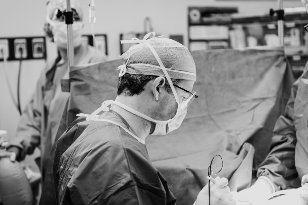 A tummy tuck surgeon performing surgery in the operating room 