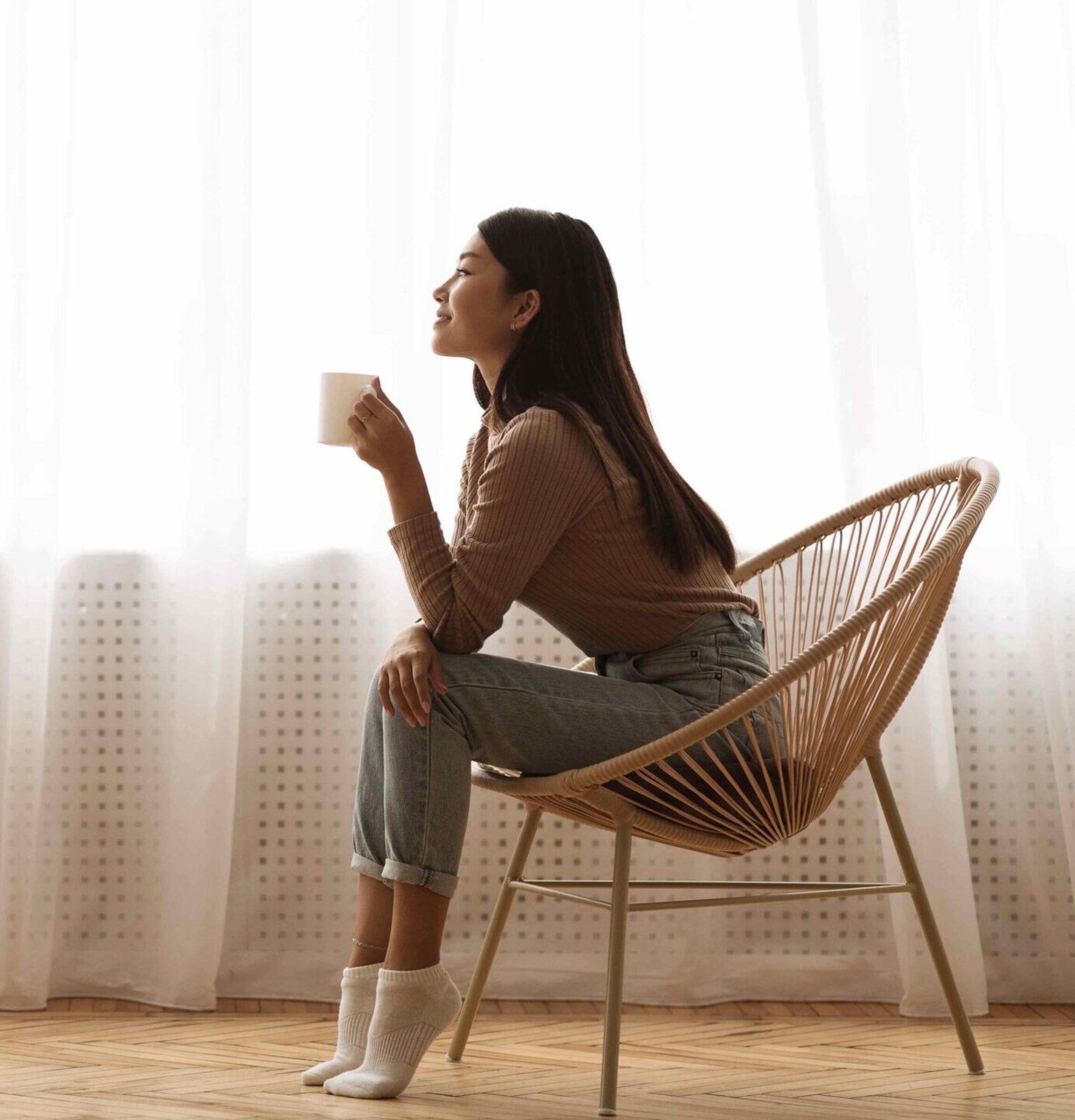 Girl Sitting in Armchair And Enjoying Coffee