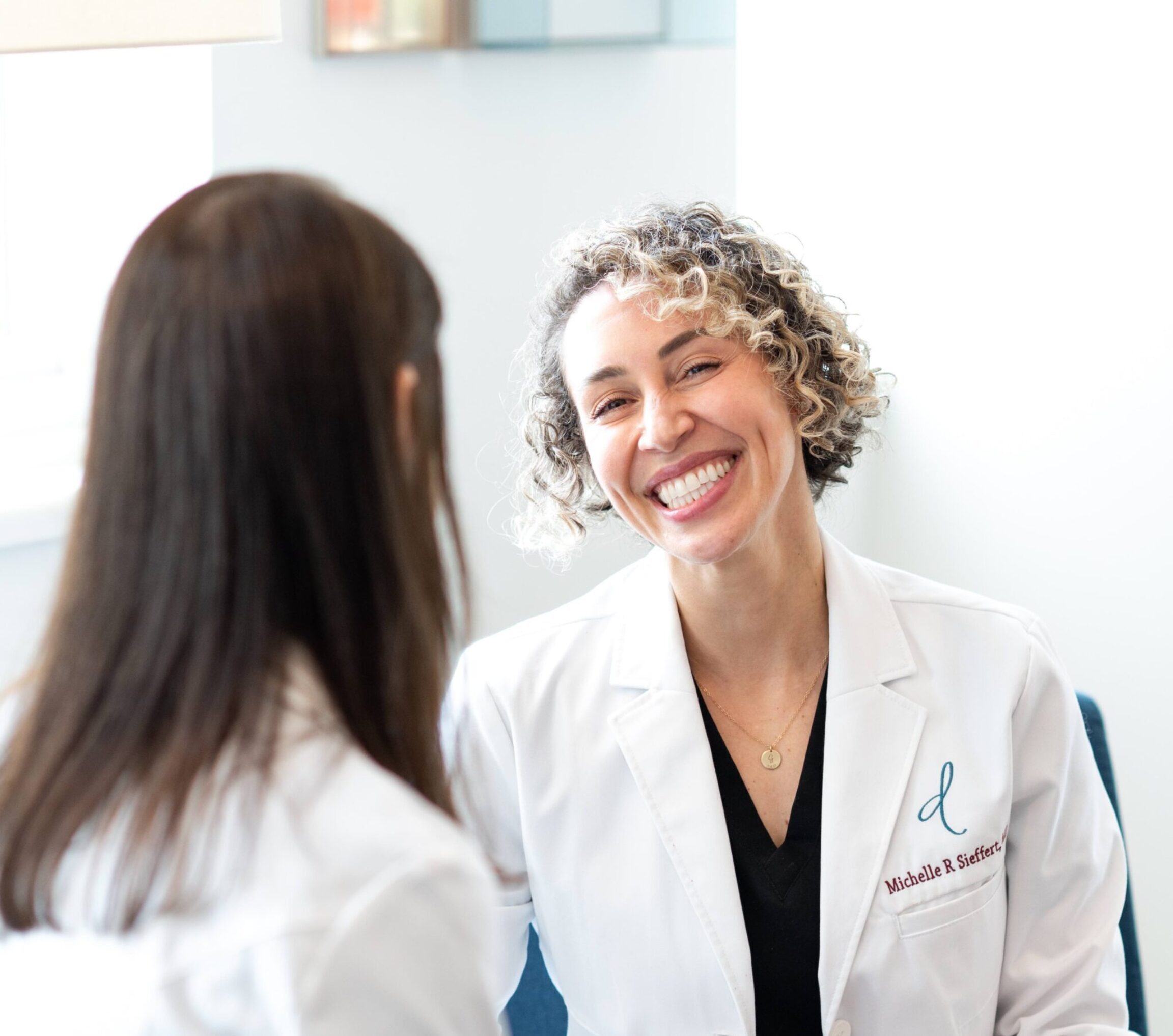 Dr. Sieffert discussing breast augmentation revision surgery with Dr. Weston