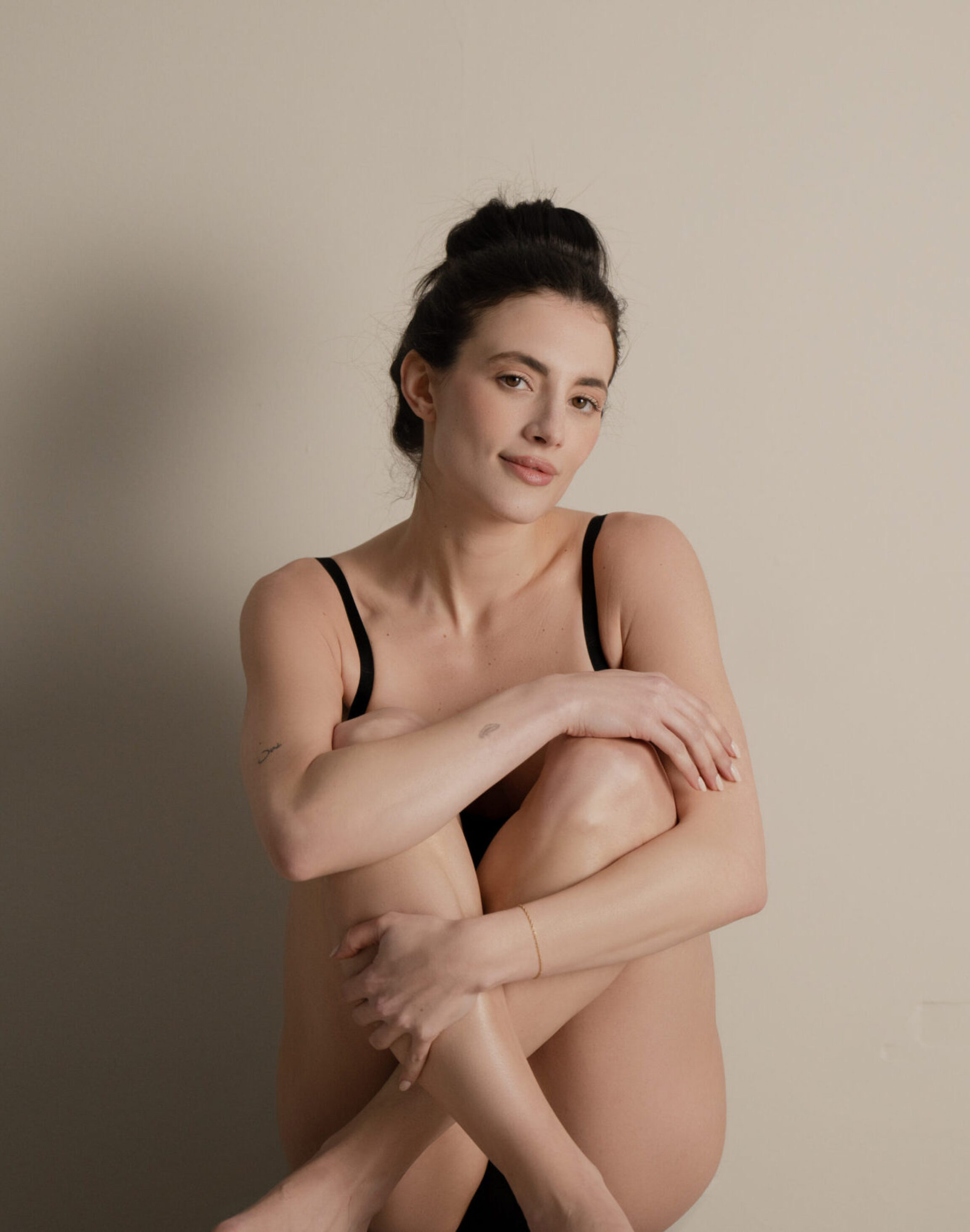 Labiaplasty patient posing with backdrop