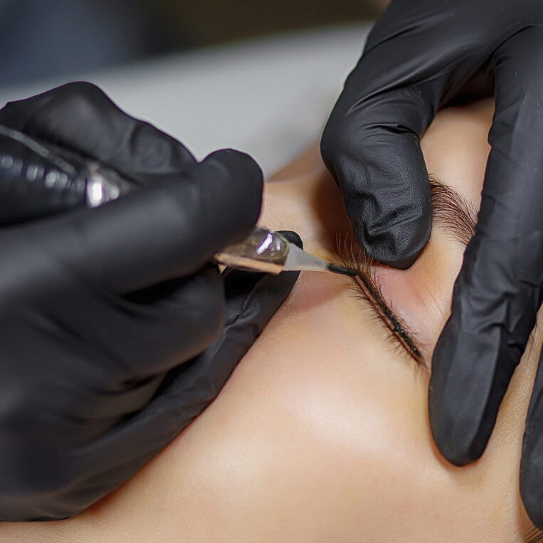 eyeliner tattooing being performed