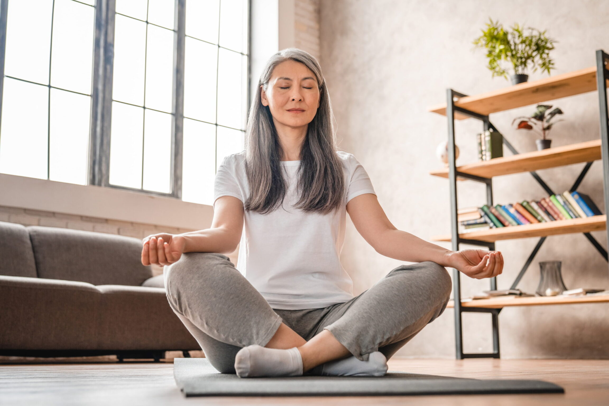 Functional Medicine patient doing yoga in her living room