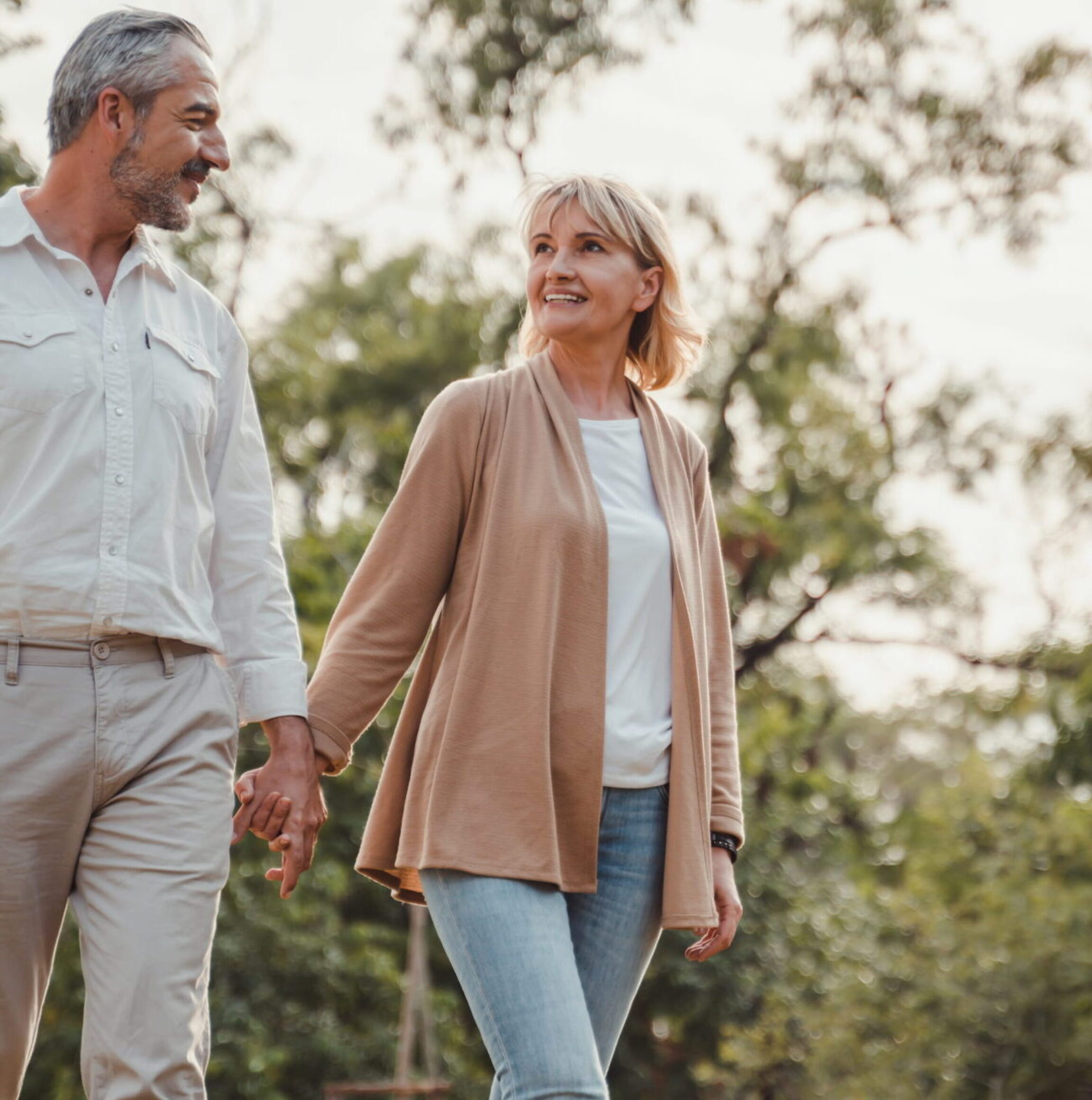 A couple who are both undergoing hormone replacement therapy walking through their neighborhood