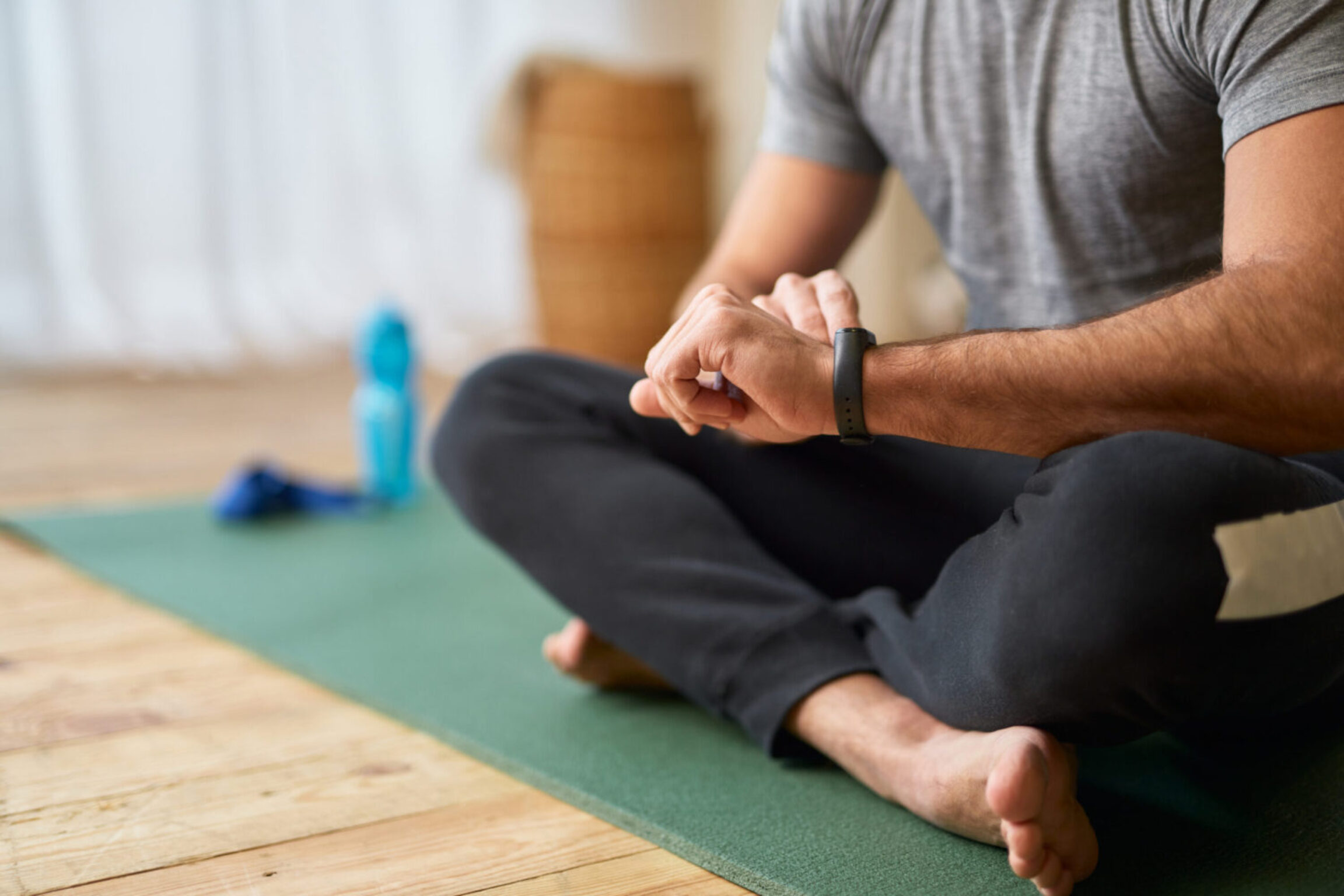 A male patient in a yoga pose practicing deep breathing