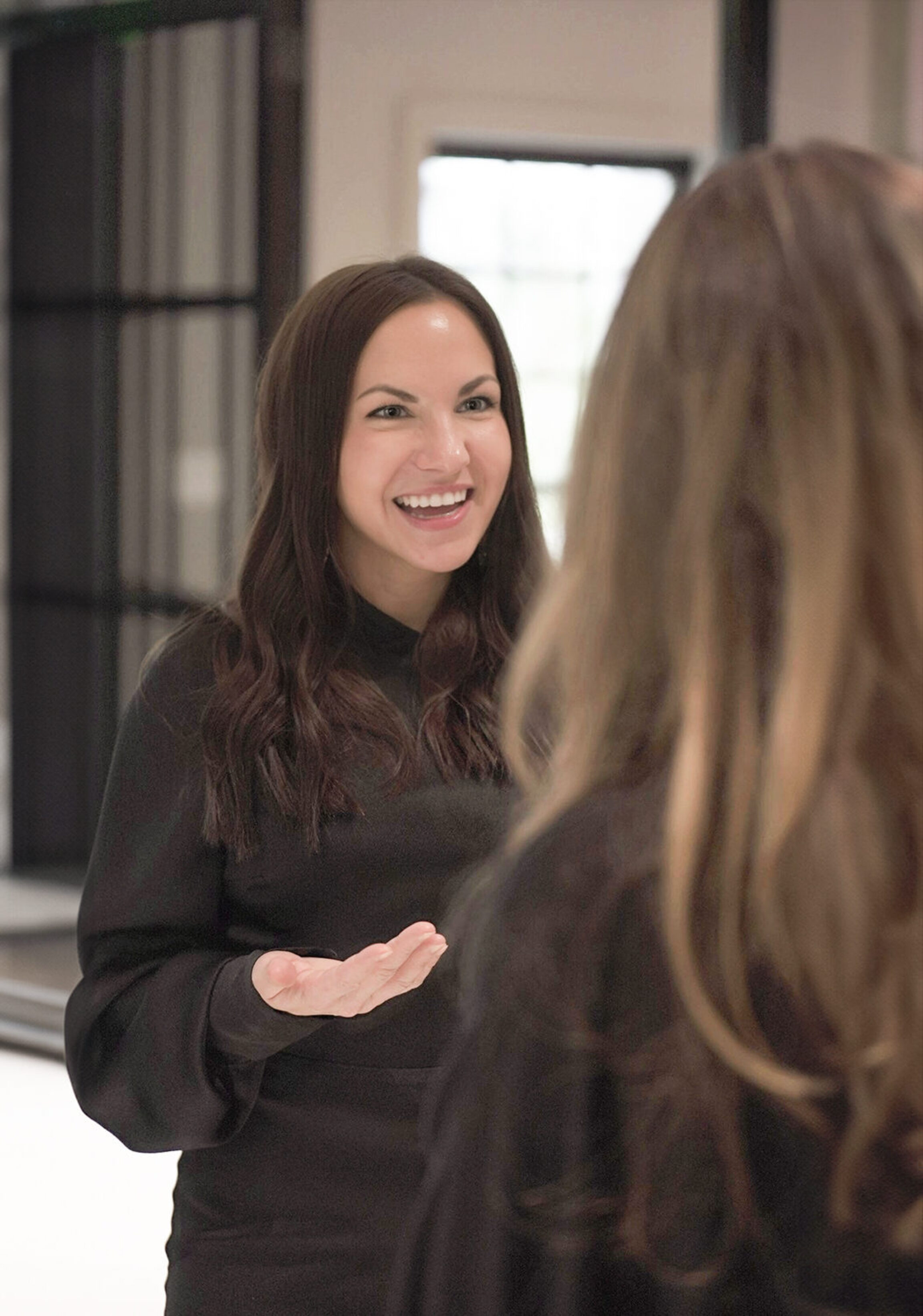 Courtney Gilbert, PA-C, discussing treatment options with a functional patient at a private event