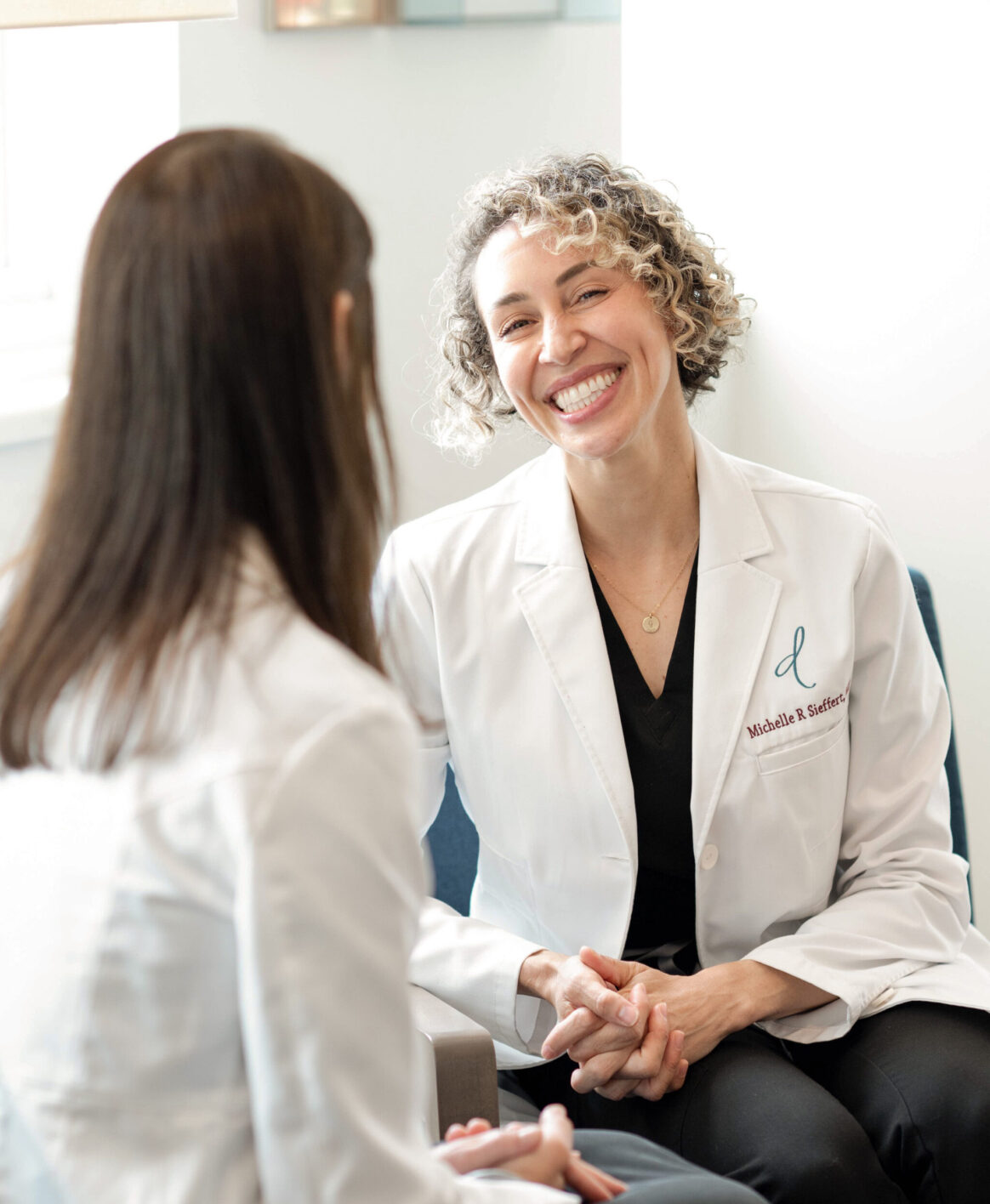 Dr. Sieffert discussing pain management methods with Dr. Weston