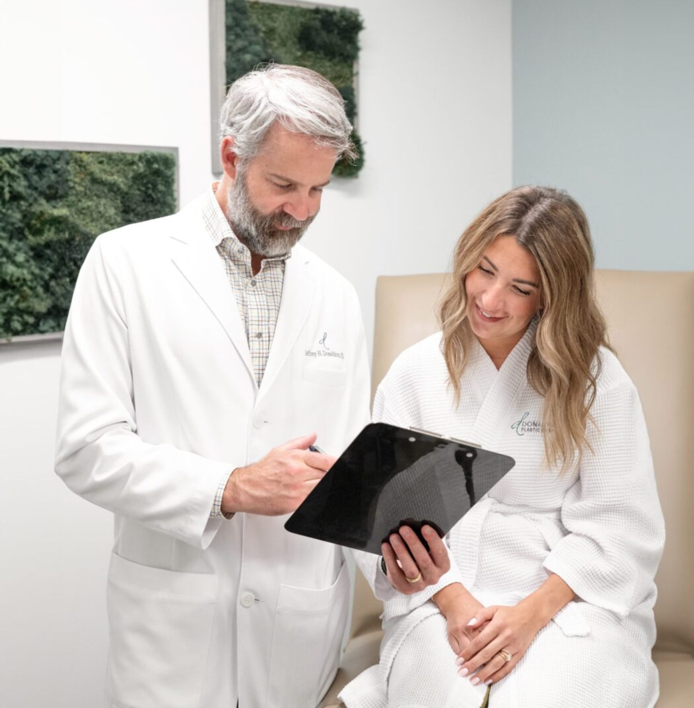 Dr. Donaldson going over breast implant options with a patient during a consultation