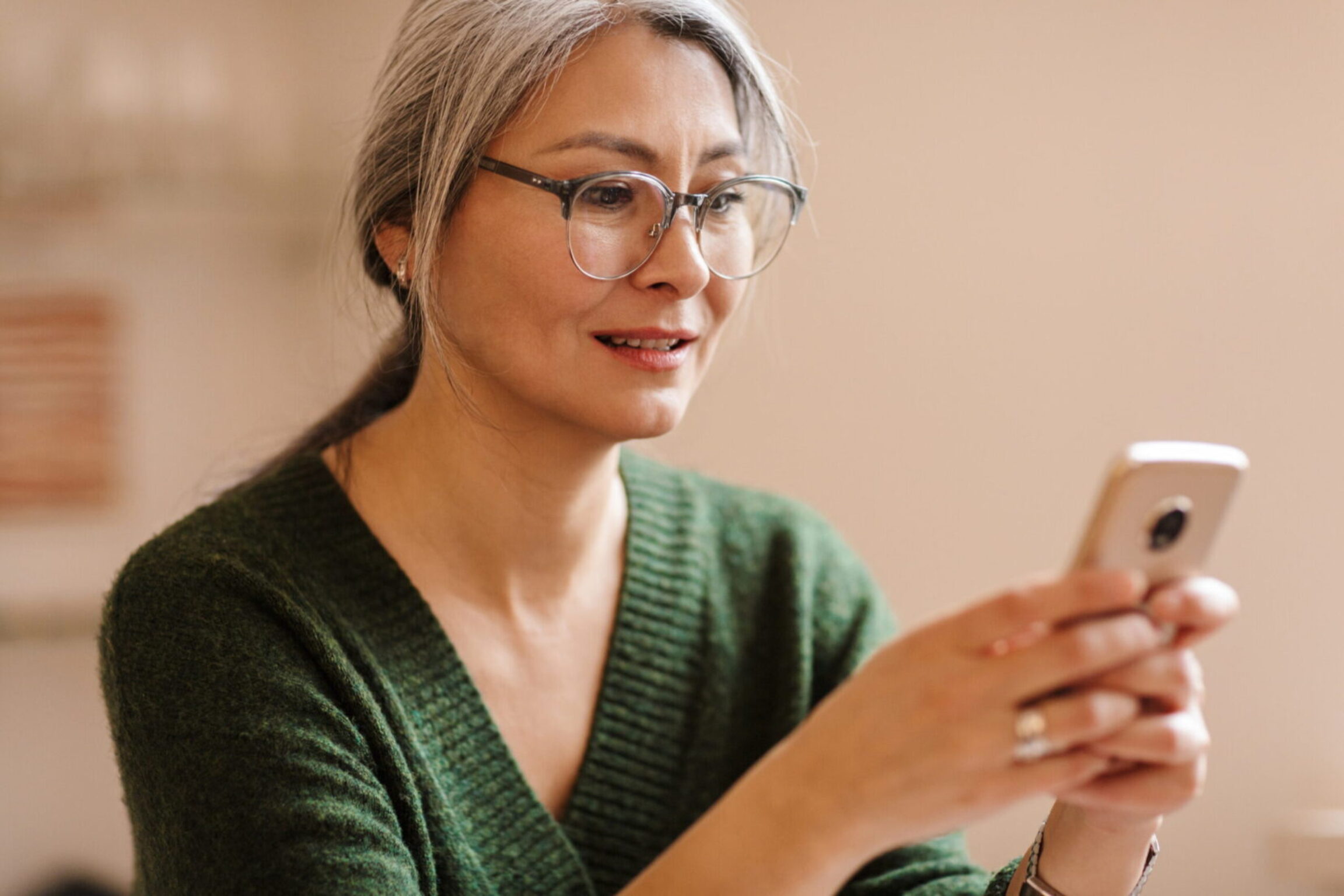 A woman using her phone to Google search the most common menopause symptoms