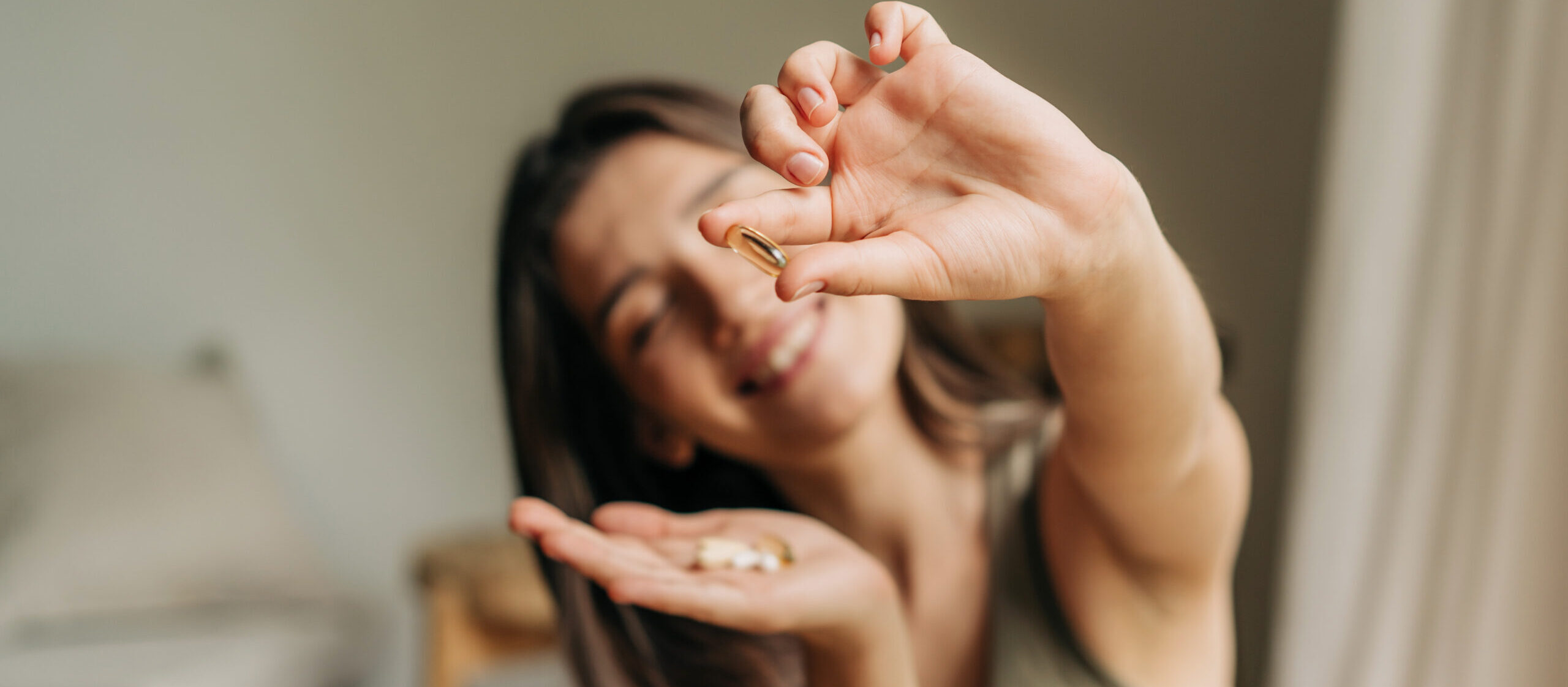 A functional weight loss patient showing off the supplements she takes during her weight loss program