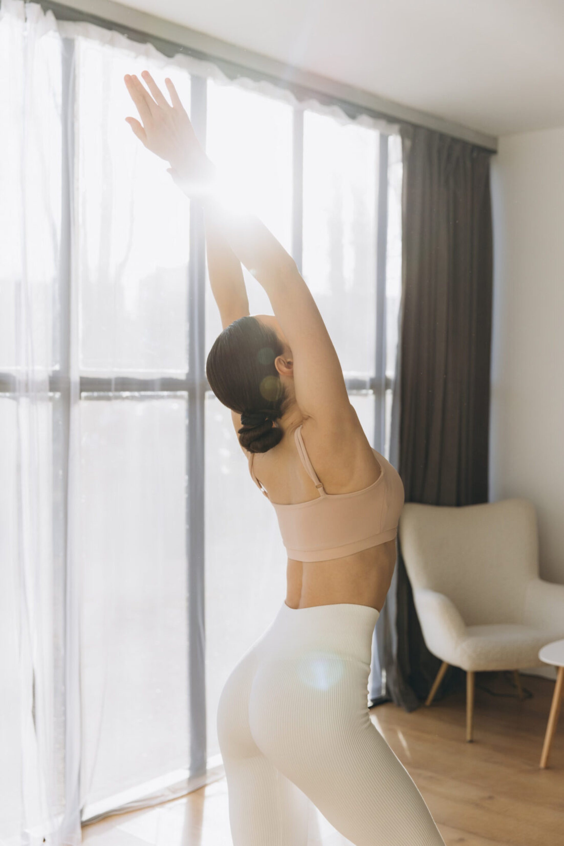 A plastic surgery patient stretching first thing in the morning after sleeping well