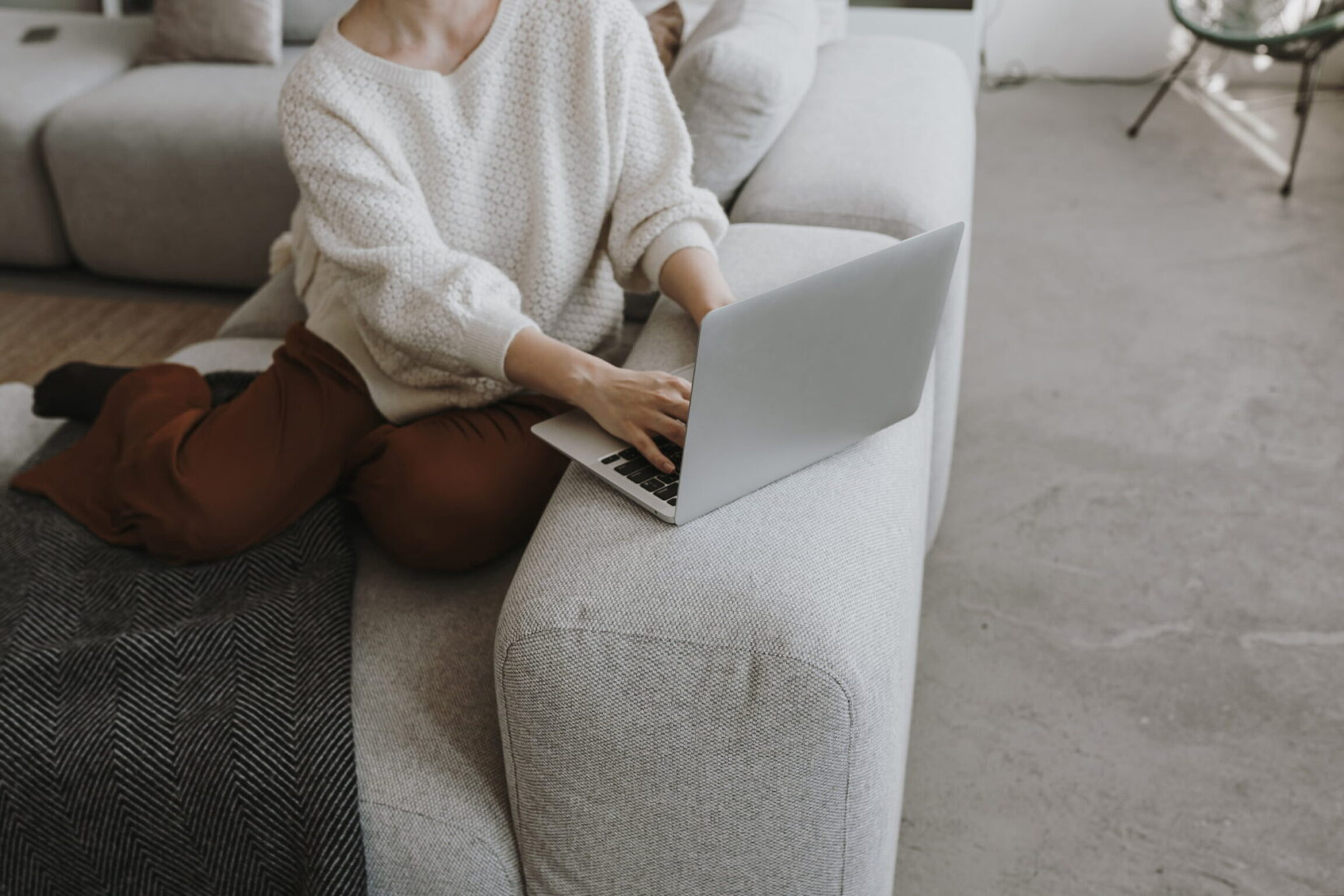 A patient looking how frequently asked questions about pre-surgery preparation at her suburban home