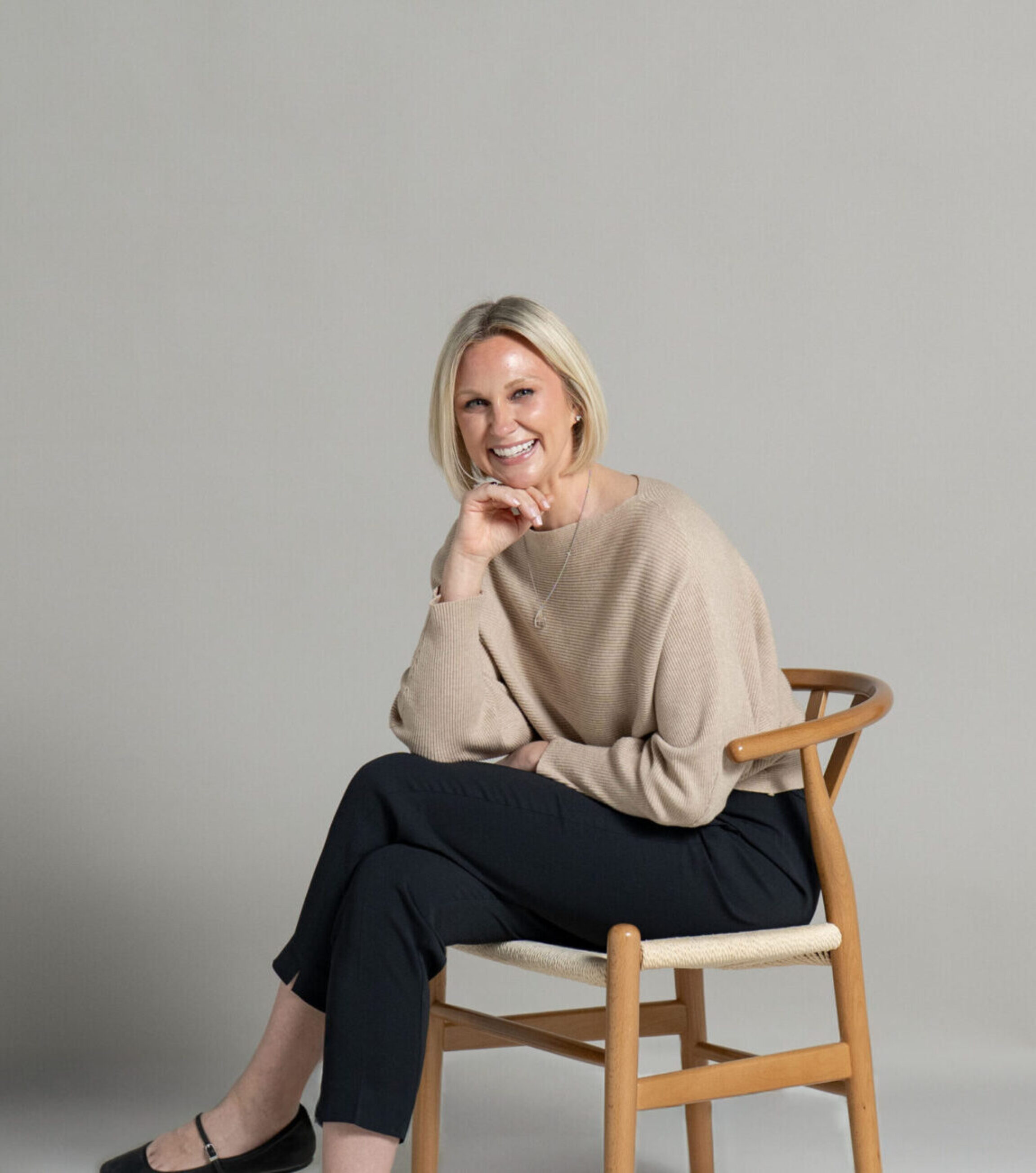 A posed photo of Colleen Bush, RDN - a Hashimoto's specialist in Columbus, Ohio - set against a muted backdrop