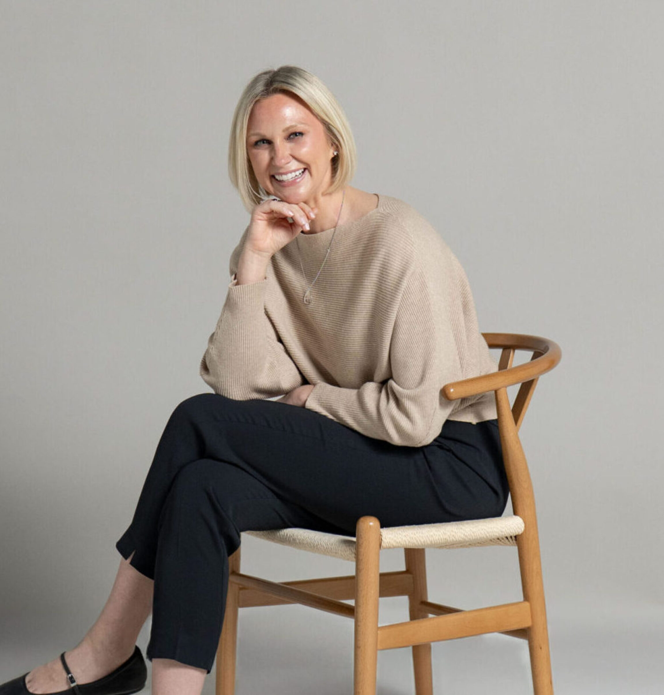 A posed photo of Colleen Bush, RDN - a Hashimoto's specialist in Columbus, Ohio - set against a muted backdrop