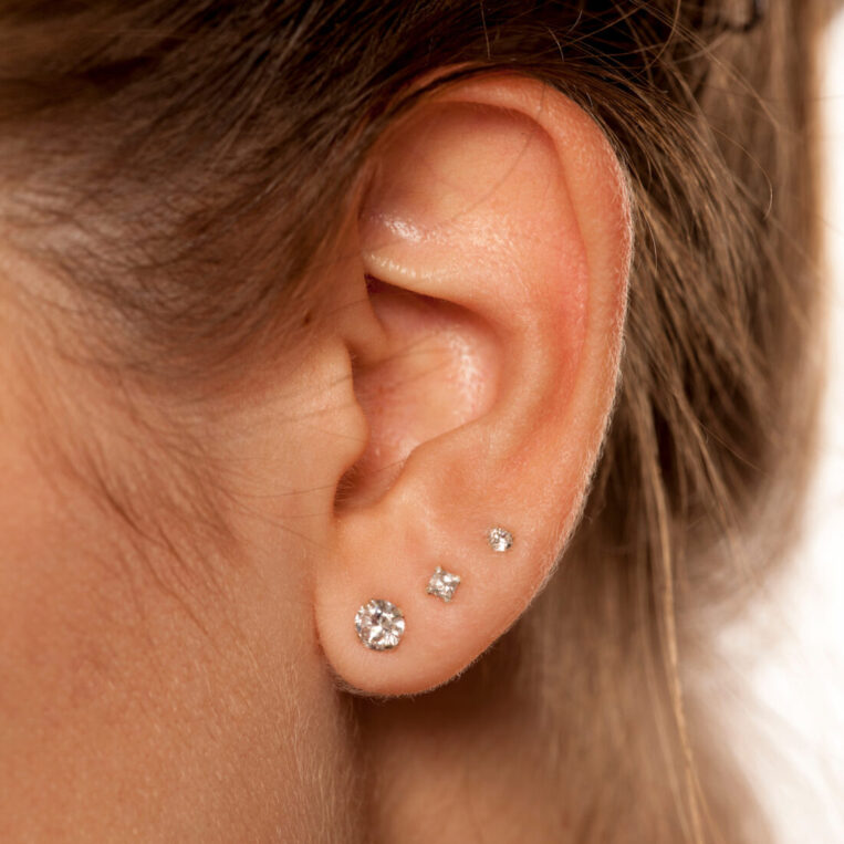 A close up photo of a woman's ear that has recently healed after an ear piercing