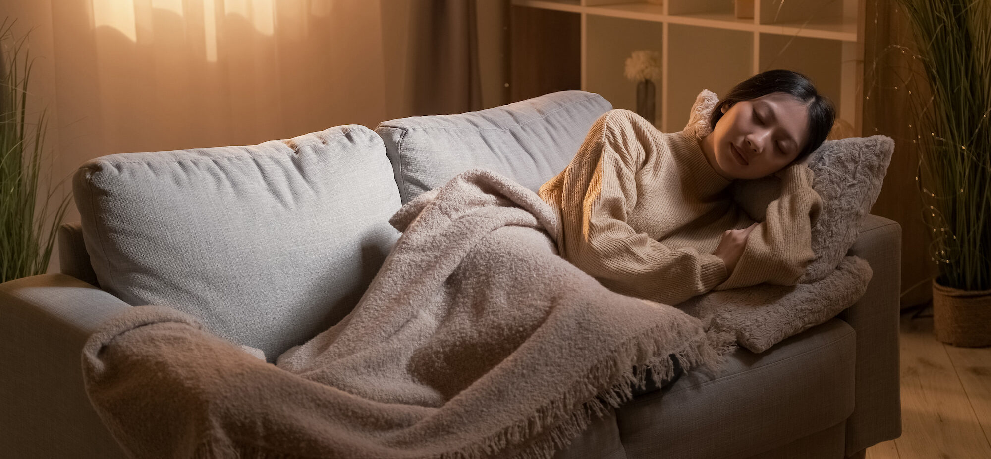 Functional medicine patient sleeping on a WayFair couch in her apartment living room