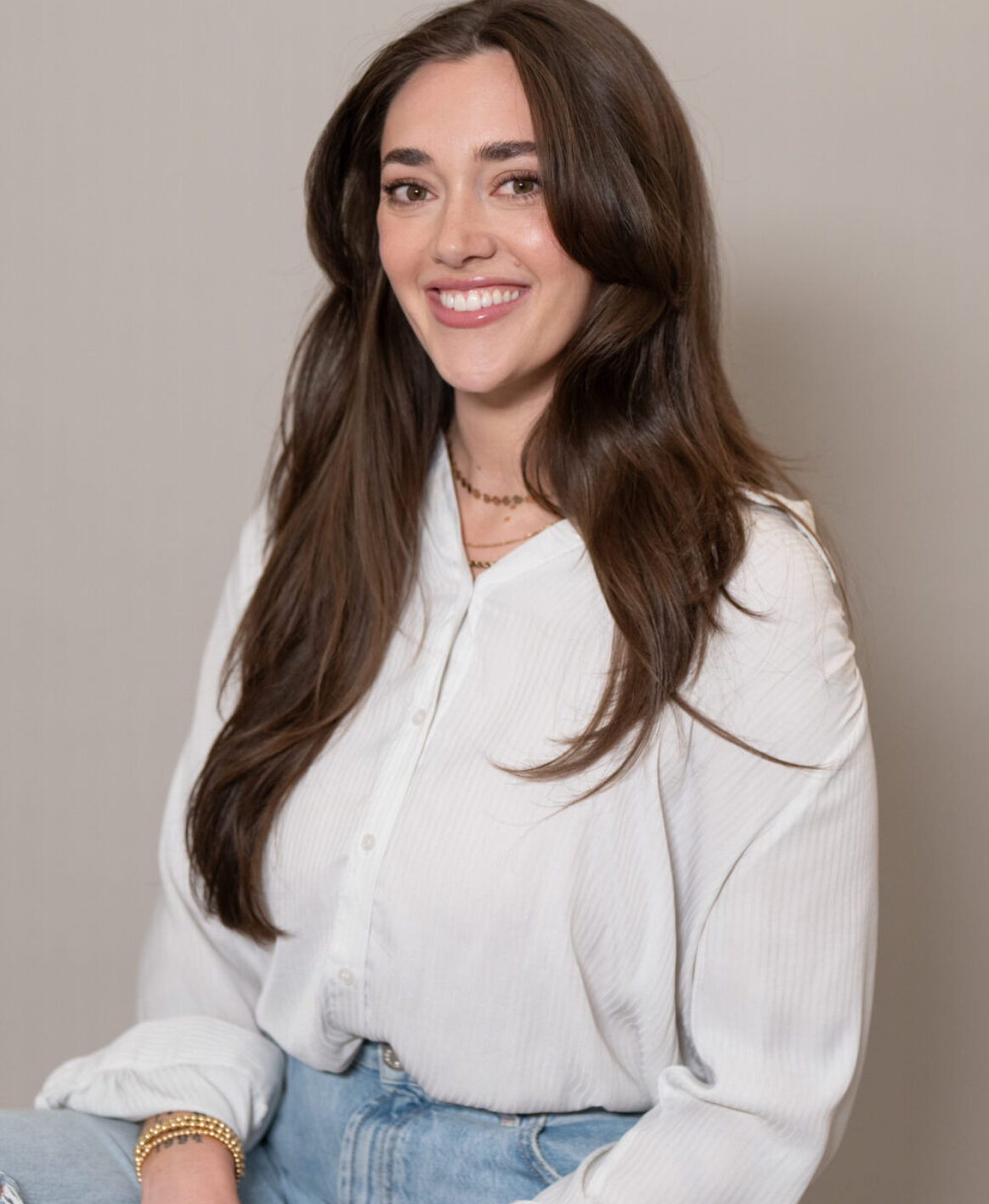 Ear Piercing specialist Andie Schroeder smiling while wearing casual clothing