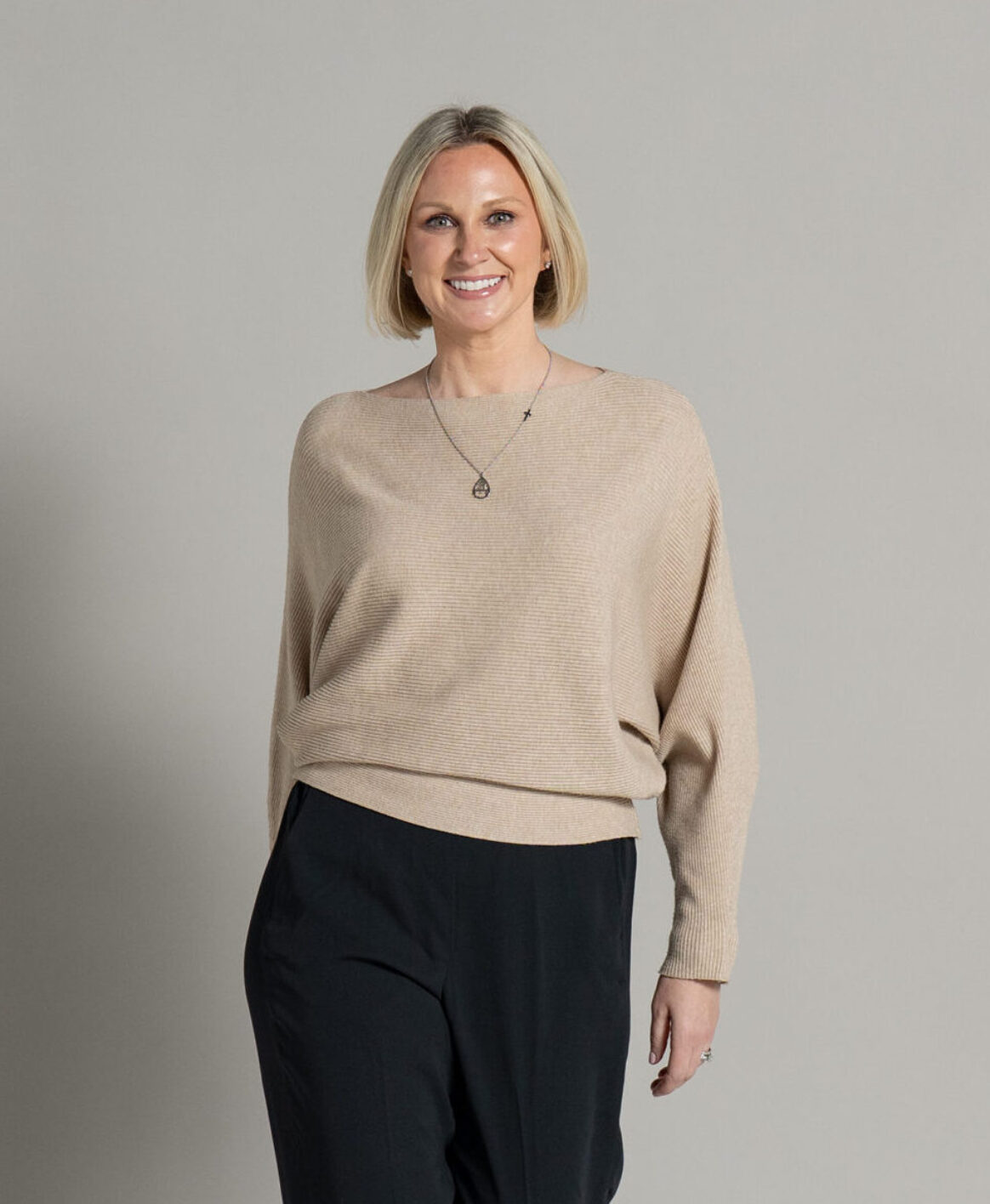 Colleen Bush, RDN, posing with a muted grey backdrop