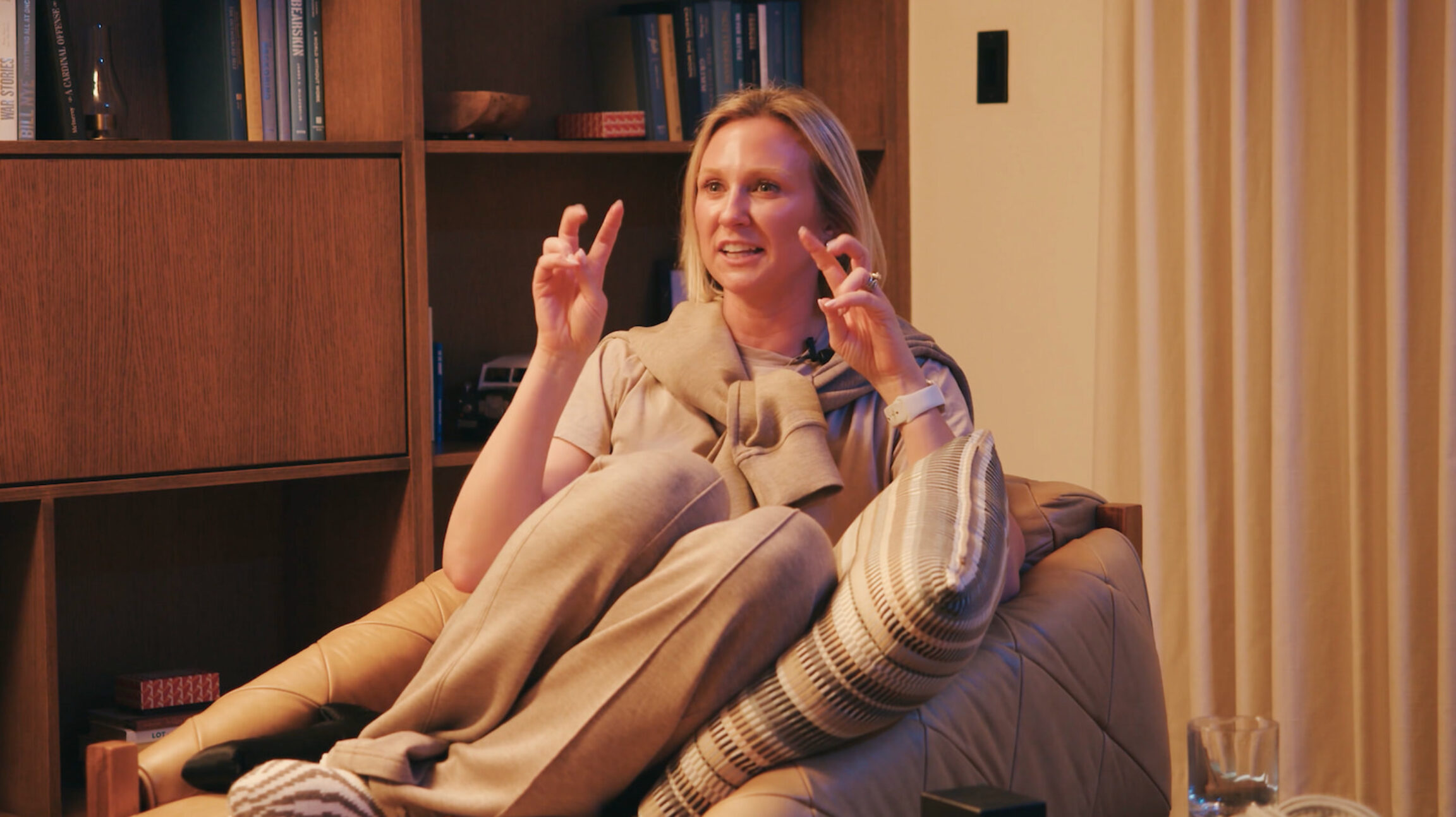 Colleen Bush discussing how gut health plays a factor in sleep quality while sitting on a comfortable chair