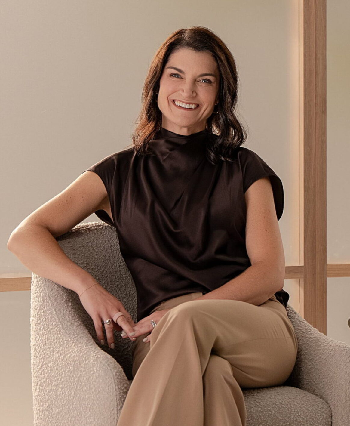 Dr. Weston sitting in an comfortable chair with a muted background