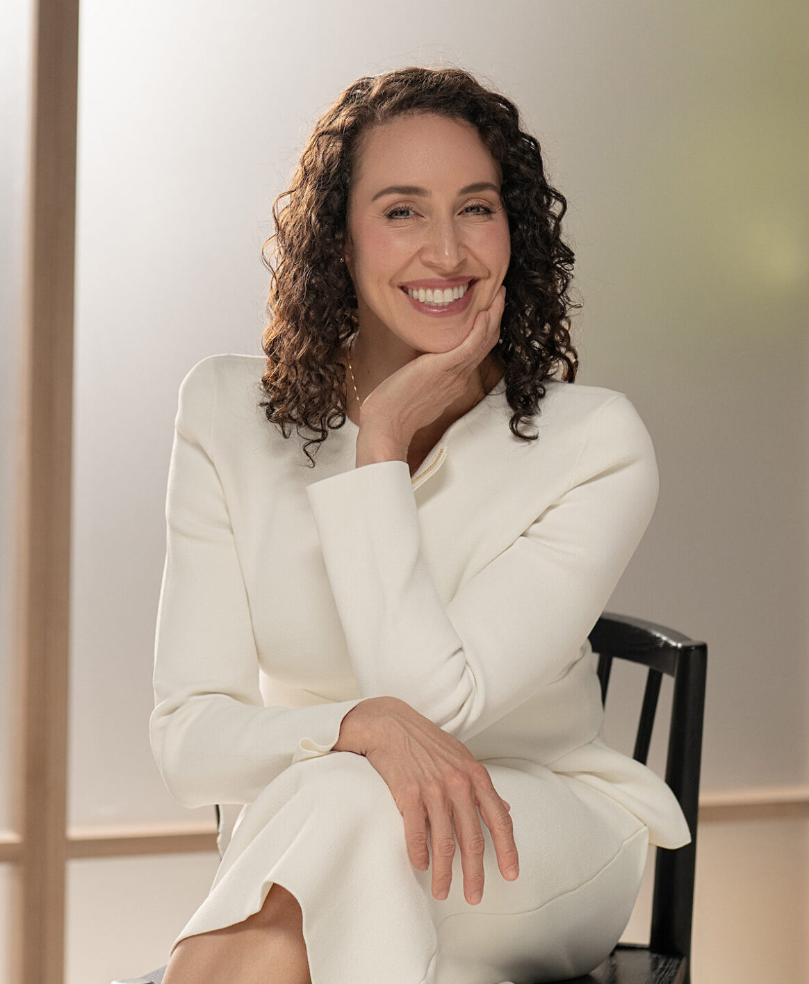 Dr. Sieffert posing against a muted, natural colour background