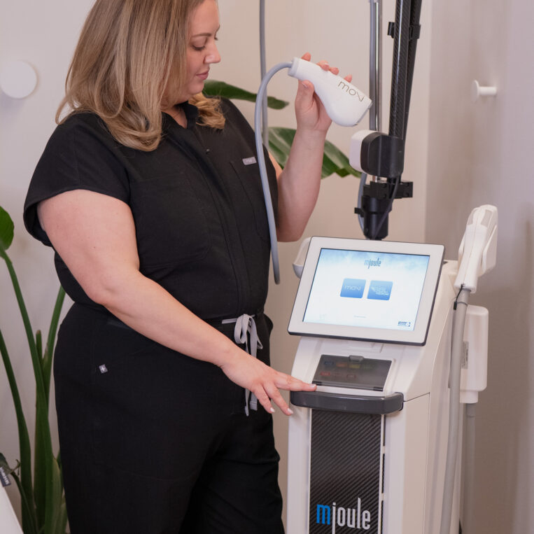 An aesthetics provider preparing a laser skin treatment device in the Dublin, Ohio office