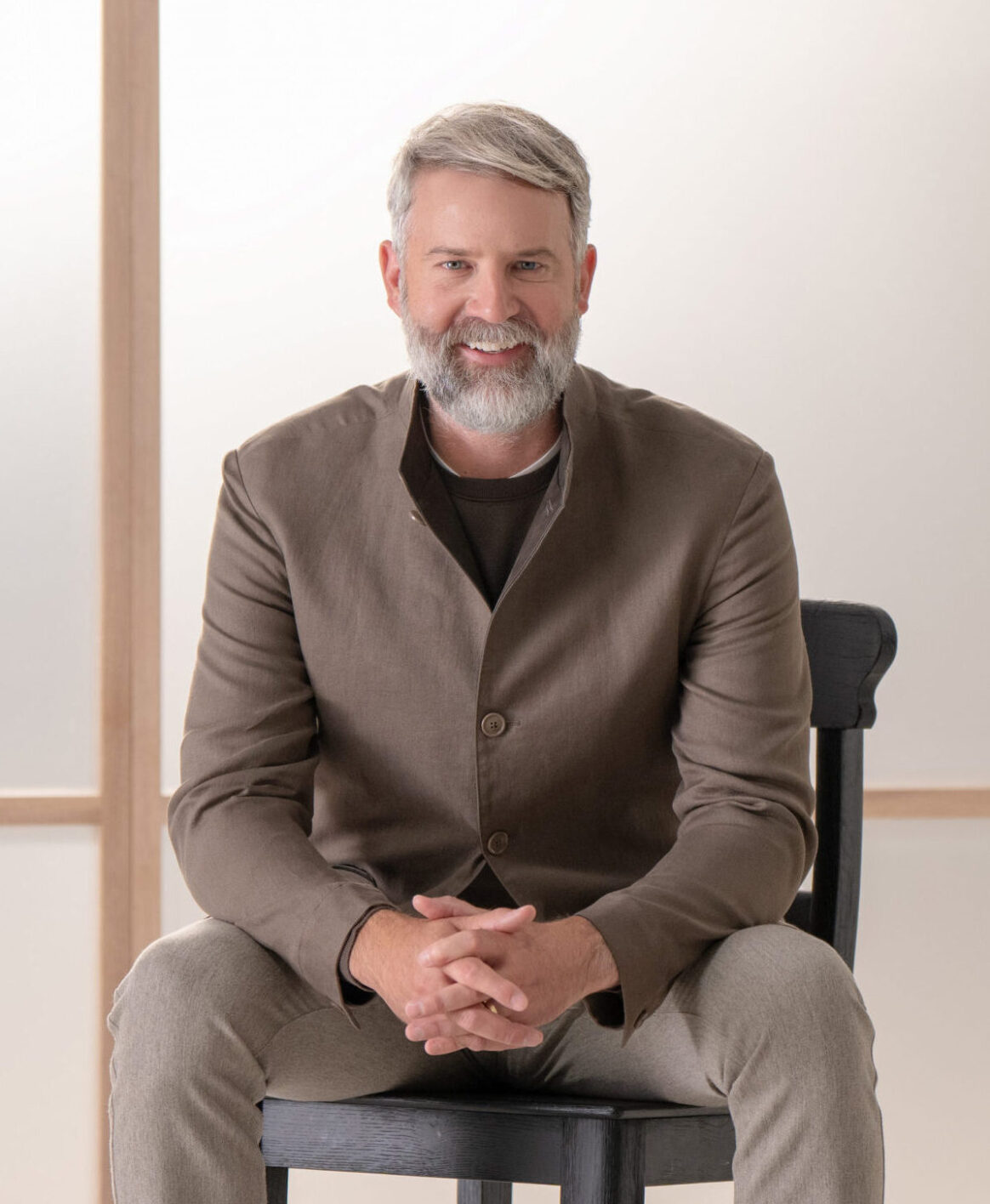 Jeffrey Donaldson, MD, posing for a photo in a brown suit against a muted background
