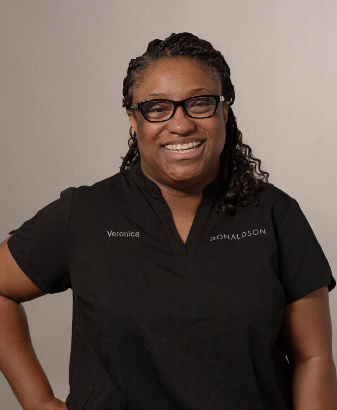 Veronica Anderson posing for a photo against a muted backdrop in the Lewis Center, Ohio office